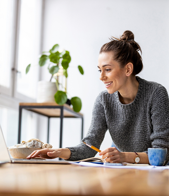 Woman scrolling on her laptop