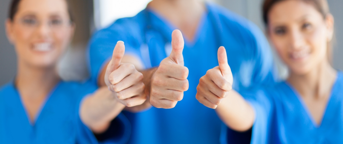 Three Jacksonville dental team members giving thumbs up