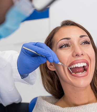 Woman in dental chair opening her mouth for a dental exam