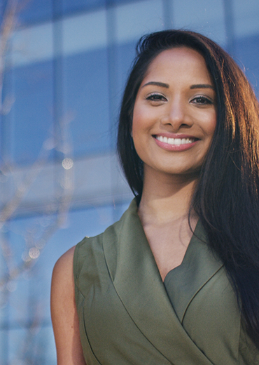 Smiling woman in sleeveless green blouse