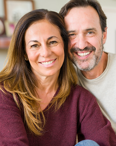 Smiling older man and woman in their home