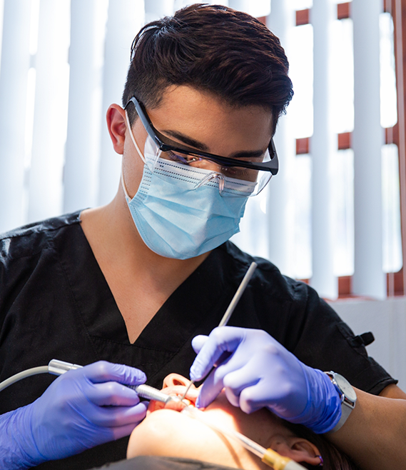 Dentist examining a patients mouth