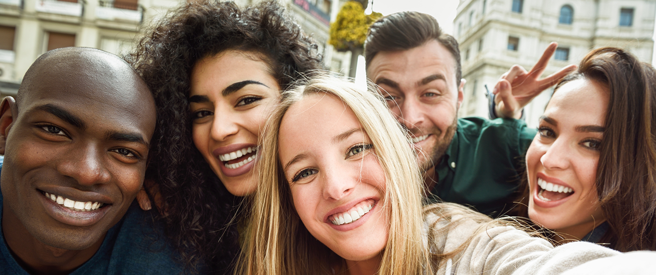 Group of smiling adults taking a selfie after restorative dentistry in Jacksonville