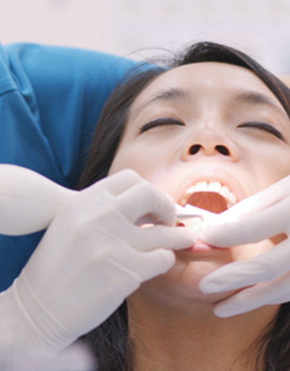 Dentist performing gum disease treatment on patient