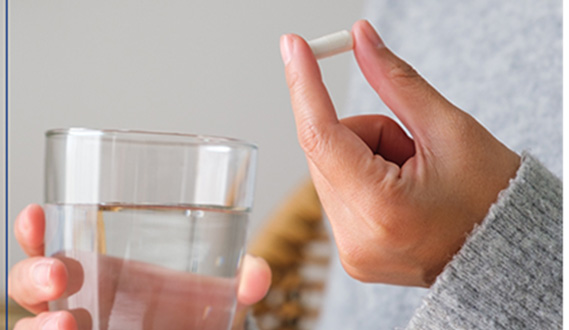 Person taking an antibiotic for gum disease